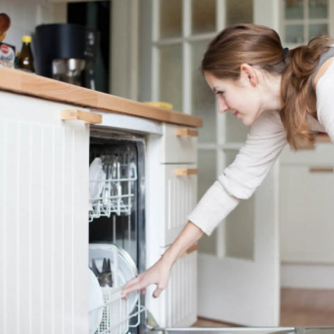 Person placing Universal Dishwasher Silverware Basket With Seven Compartments And Handle For Easy Cutlery Organization into dishwasher