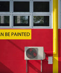 Exterior wall with 3 Inch Wide 10 Foot Line Set Cover Kit for Mini Split AC Systems, painted red with visible AC unit.