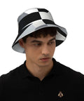 Fire Black And White Piano Grid Print Bucket Hat With Double Sided Reflective Trim unisex lightweight polyester worn by man.