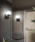 Mid Century Modern Black Wall Sconce With Milky Glass Shade 1 Light Indoor Wall Lamp for living room, hallway view