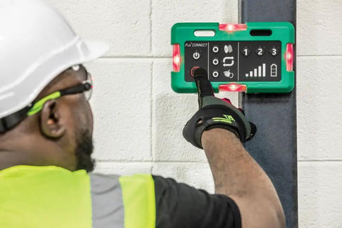 Operator using the Three Piece Wireless Cable Pulling Signal System With Magnets And Bright LED Visuals For Noise Free Jobsite Comms.