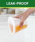 Person holding 50 Pack 32 Ounces Deli Containers With Lids Leak Proof BPA Free Plastic Takeout Bowls tilted without spilling