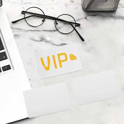 Twenty Piece Bundle Of Slick Blank White Pvc Id Cards With Heavy Duty Waterproof Coating And Hassle Free Printing For Quick Employee Badges And Double Sided Photo Cards In Sharp Resolution, showcasing VIP card on a desk.