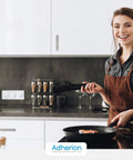 Smiling woman cooking in modern kitchen with 5 Inch Brushed Nickel Adhesive Cabinet Handles Set Of 4 All Metal Self Stick Drawer Pulls installed.