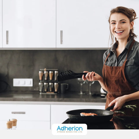 Smiling woman cooking in modern kitchen with 5 Inch Brushed Nickel Adhesive Cabinet Handles Set Of 4 All Metal Self Stick Drawer Pulls installed.