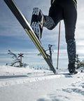 Ski mountaineer using Twin Skin 100 Percent Mohair Neon Yellow Wide Replacement Skins for backcountry touring, showing grip and glide.