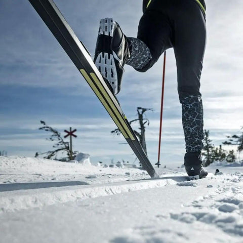 Ski mountaineer using Twin Skin 100 Percent Mohair Neon Yellow Wide Replacement Skins for backcountry touring, showing grip and glide.