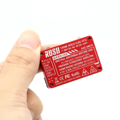 Hand holding 5.8G VTX Video Transmitter 1.6W High Power With Built In Microphone, compact CNC shell, red details visible.