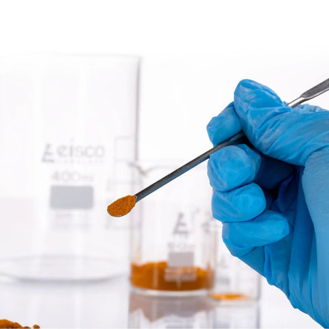 Stainless Steel Micro Spatula With Spoon End 6 Inch Dual End Precision Tool For Lab Sampling And Mixing, Durable Stainless Steel Construction For Precise Measuring And Transferring Tiny Bits In The Lab. gloved hand holding spoon-end micro spatula with powder