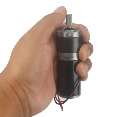Beefy Micro Planetary Gear Motor With 32mm Planet Reducer in hand, showcasing durable metal body and wires