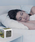 Tractor Farm Alarm Clock With 7 Color Changing Night Light on bedside table near sleeping woman, showing time and temperature.