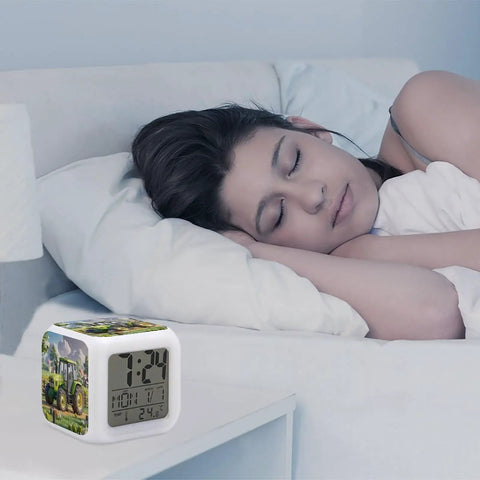 Tractor Farm Alarm Clock With 7 Color Changing Night Light on bedside table near sleeping woman, showing time and temperature.
