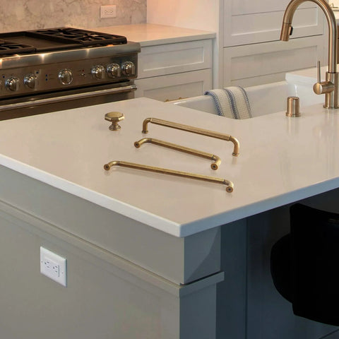 Six Pack Antique Brass Zinc Alloy Cabinet Pulls With 5 Inch Hole Center displayed on kitchen counter