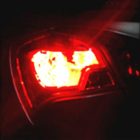Rear view of car with Red 3156 3157 LED Turn Signal Bulbs For T25 Set Of 2 Hella Bright Back Up Reverse Brake Tail Lights illuminated