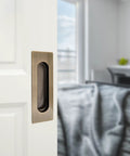 Slick And Hella Sturdy 4.7 Inch Rectangle Recessed Door Handles With Comfortable Oval Finger Flush Pulls For Barn And Sliding Pocket Doors Rust Resistant Stainless Steel Set Of Two on a white door.