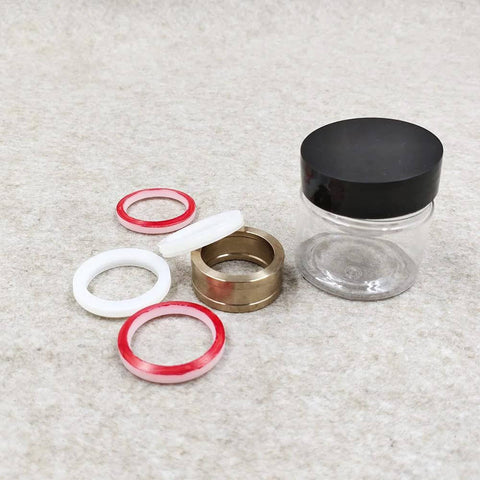 Seal assembly kit for HP waterjet cutter; brass ring, two red O-rings, two white O-rings, and spacers.