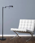 Dimmable LED Pharmacy Floor Lamp With Full Range Dimming And 360 Degree Swing Arms beside a white chair