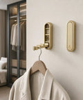 Sleek Black Folding Wall Hooks Four Pack With Swivel Hinge Design Perfect For Tight Spaces And Narrow Hallways No Hassle Kickback Mount holding a coat.