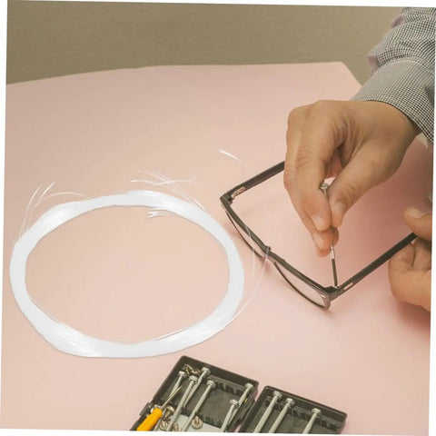 Eyeglass Repair String For Half Frame Glasses Compact Lightweight Maintenance Tool With Nylon Thread for quick fixes shown in use.