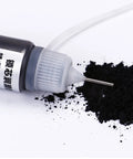 Graphite Powder Lubricant For Locks And Hinges 15ml bottle with applicator tip and spilled powder on surface.