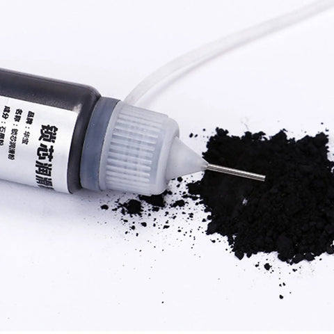 Graphite Powder Lubricant For Locks And Hinges 15ml bottle with applicator tip and spilled powder on surface.