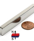 Neodymium Bar Magnet N45 3 By One Half By One Quarter Inch With 3M Foam Adhesive shown next to a penny for scale.