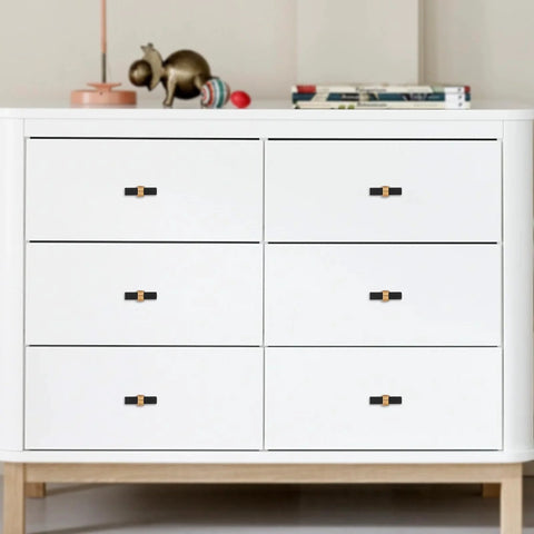 White chest adorned with 10 Pack Knurled Cabinet Knobs Matte Black And Champagne Bronze Set, shown installed on drawers.