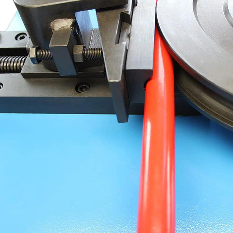 Heavy Duty Programmable Electric Tube Bender With PLC And 2 HP Motor Bends 5/8 To 1-1/2 Inch Tubing close-up of bending red tubing in machine.