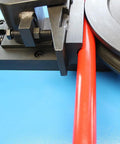 Close-up of High Octane Programmable Electric Tube Bender With 2Hp Motor Hits 1680 Rpm, bending red tubing with precision.