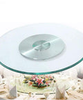Heavy Duty Lazy Susan Turntable Plate 60-120 cm with clear tempered glass top and aluminum base on dining table.