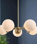 Soft Gold Globe Chandelier With Five Lights And White Glass Shades, Mid Century Modern Pendant Ceiling Light in living room