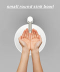 Top view of 11 Inch Vessel Sink Bowl For Small Bathrooms with hands under faucet, Above-Counter Round White Ceramic Lavatory Wash Basin