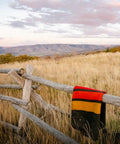 Heavyweight Wool Blanket For Cold Nights Camping Ready Outdoor Essential draped over wooden fence in a field