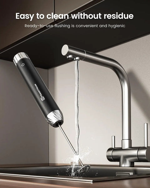 Rechargeable Milk Frother With Game-Changer Stepless Speed Control, LunaFro Max being rinsed under a faucet in a kitchen sink
