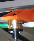 Close-up of a brass coupler for 3D printer Z-axis T8 lead screw installed, showing Boss Level Precision Coupling Set to minimize play and wobble.