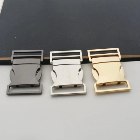 Three 25mm metal side release buckles in black, silver, and light gold. Built Tough 25mm Side Release Buckle Set 5 Pack Metal Quick Release Buckles For Paracord Bracelets Dog Collars Harnesses Backpacks Webbing And Leather DIY Projects Light Gold Finish visible on display surface.