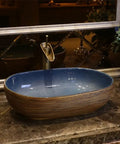 USZWBY Vessel Sinks Bathroom Vessel Sink Oval Ceramic Washbasin Vintage Art Countertop Basin with blue interior on marble surface