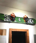 Heavy Duty Snowboard Wall Mount Rack For Garage Organization And Wall Storage, displaying snowboard with orange bindings
