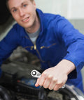 Quarter Inch Ratchet Socket Wrench With Quick Grip For Easy Bolt Fastening And Smooth Auto Repair Work being held by a mechanic.