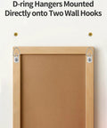 140 Piece Rock Solid D Ring Picture Hanger Screw Kit With Single And Double Hole D Rings For Hanging Heavy Frames Mirrors Canvas Wall Art With Easy Mounting Hardware For Quick Room Glow Up. D-ring hangers mounted on wall hooks.