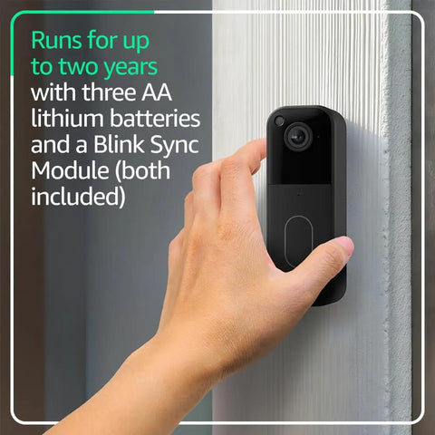 Second Gen Smart Video Doorbell With Head To Toe HD View And Two Year Battery Life Includes Sync Module Core Plus One Year AI Plan For Crisp Clips And No Sweat Plug And Play Setup Straight From The Box Black mounted on a door frame, being installed with a hand.