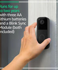 Hassle Free Wireless Smart Video Doorbell And Four Rugged Outdoor Security Cameras With Two Year Battery Life And Extended Range Up To Four Hundred Feet Includes Sync Module For Rock Solid Coverage And Smooth Everyday Monitoring, mounted on a wall.