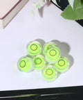 10pcs Circular Bubble Spirit Level for Calibration Picture Frame, group of round acrylic levels with green bubbles on a white surface.