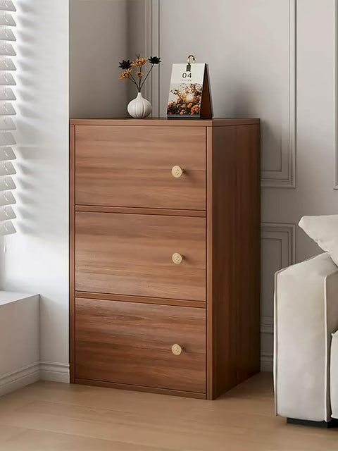 Round zinc knobs from Champagne Bronze Cabinet Knobs Set 12 Pack on wooden cabinet drawer, warm gold tone finish.