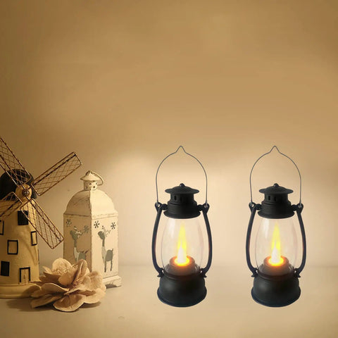 5.1 Inch Mini Lanterns Six Pack LED Candle Lanterns with flickering warm flame next to decorative ornaments on a shelf