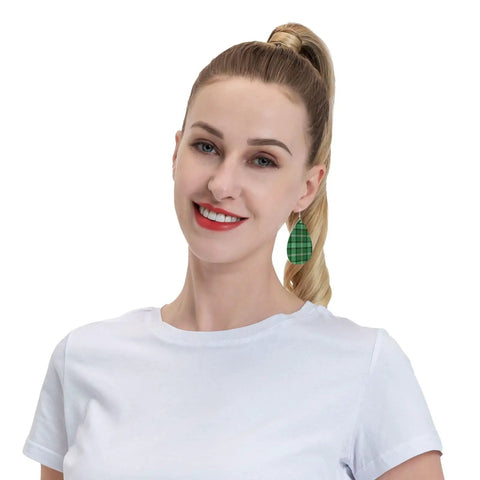 Totally Fire Green Grid Teardrop Faux Leather Dangle Earrings With Silver Plated Hooks worn by a woman in a white shirt.