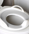 Toddler Potty Training Seat With Sure Grip Handles And Non Slip Base For An Easy Peasy Transition To The Big Toilet Includes Splash Guard Plus Handy Wall Hook Gray on a toilet.