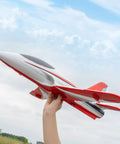 Person holding 50mm EDF Jet RC Plane For Adults, 4 Channel Remote Control Airplane, red, outdoors against sky.