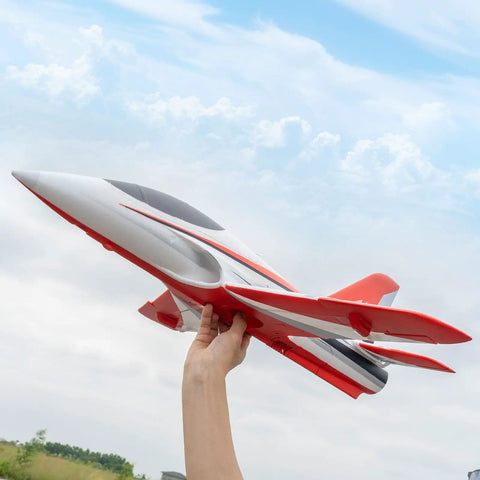 Person holding 50mm EDF Jet RC Plane For Adults, 4 Channel Remote Control Airplane, red, outdoors against sky.