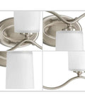 Close-up of Three Light Brushed Nickel Bath Vanity Light With Etched Glass Shades for Traditional Bathroom Style Classic Fixture